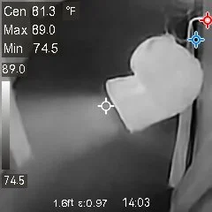 Thermal inspection image showing temperatures around plumbing